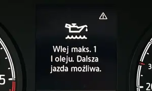Kontrolka z symbolem oleju i komunikatem "Wlej maks. 1 l oleju. Dalsza jazda możliwa." ostrzega przed niskim poziomem oleju w silniku.